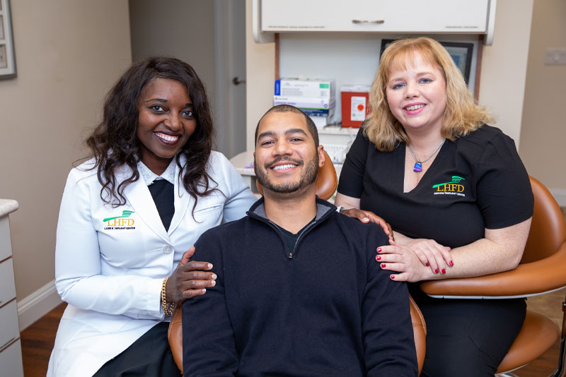 dr bola mooney and dental patient smiling